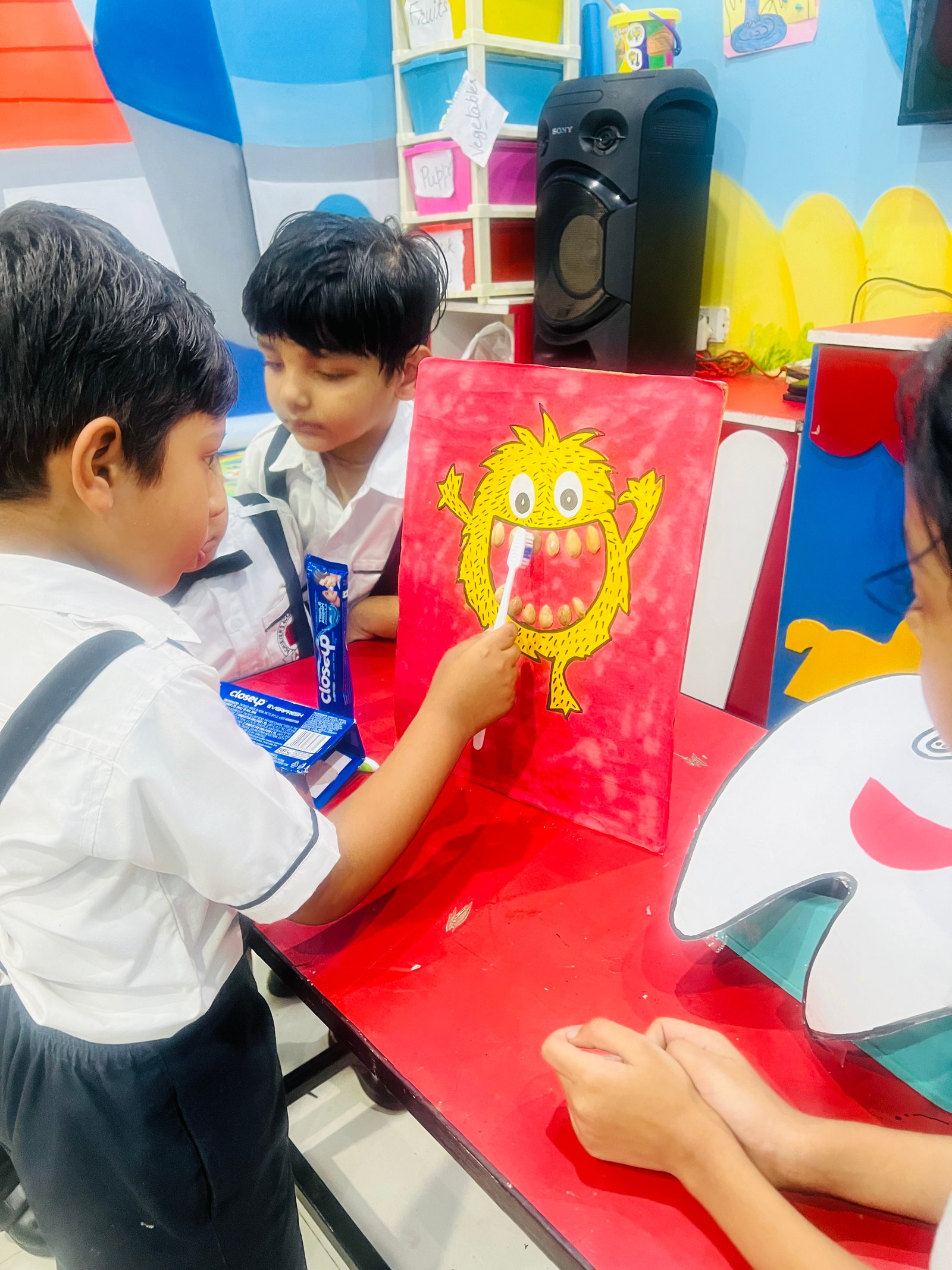 Dental Care Practice - Boy brushing teeth of a cartoon monster