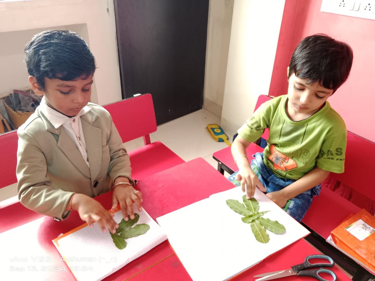 Creative Leaf Craft - Students pasting leaves to create art